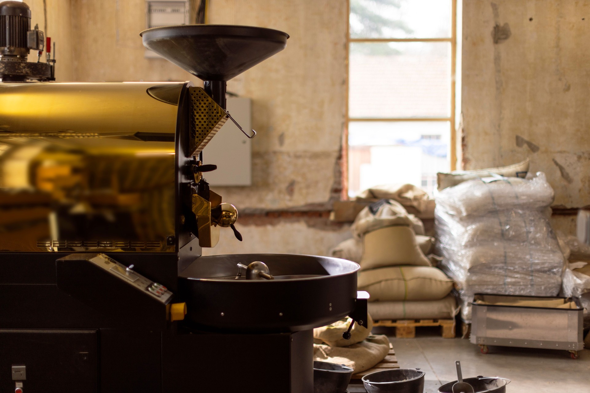 Industrial Coffee Roasting Machine in Rustic Warehouse Environment